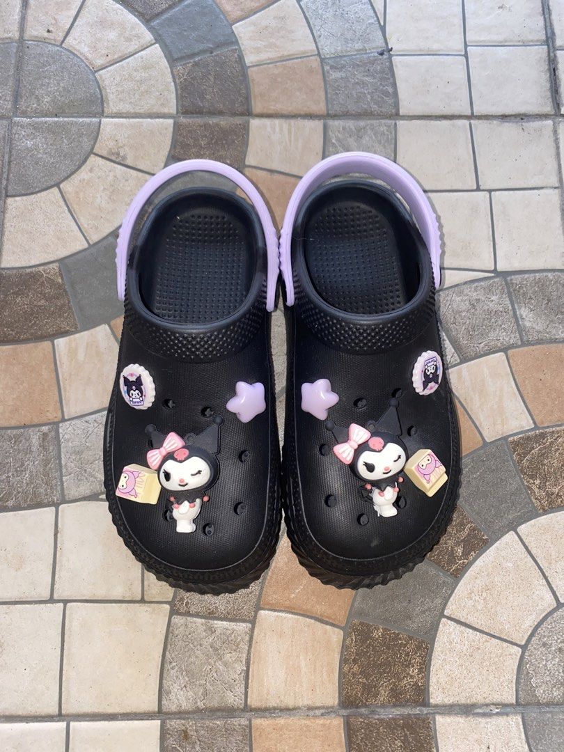Black Kuromi Clogs with Charms Size 38 (Category: Slippers and slides) located in Pasay City. Submitted by violetttttttttttttt (Listing ID 1460579495, Image 1). Description: - Cute black clogs with adorable Kuromi charms - Features a light purple strap and sole accents - Wavy patterned sole for enhanced grip - Size 38 - Ideal for casual wear and lounging - Fun and playful design - Bought in Bangkok, Thailand.