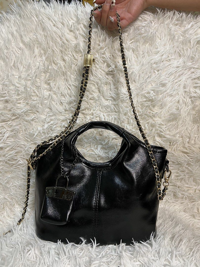 Black Leather Handbag with Chain Strap and Mini Pouch (Category: Purses & Pouches) located in Manila. Submitted by yanya97 (Listing ID 1460543407, Image 1). Description: Black leather handbag. Has a top handle and a detachable chain strap. Comes with a small matching pouch attached. Interior is spacious. Gold-tone hardware. Great for everyday use or nights out..