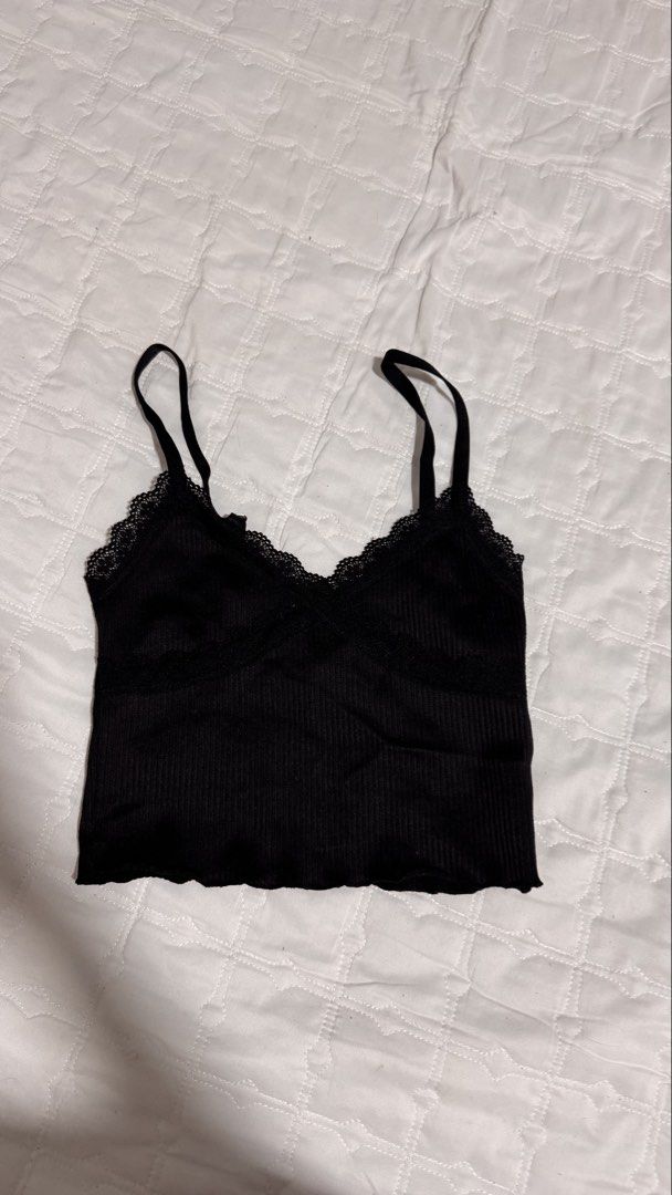 Black ribbed lace trim cami top (Category: Sleeveless) located in Manila. Submitted by wildlion_020304 (Listing ID 1460673150, Image 1). Description: - Black ribbed cami top - Lace trim on neckline and hem - Adjustable spaghetti straps - Cropped length - Versatile for layering or wearing alone.