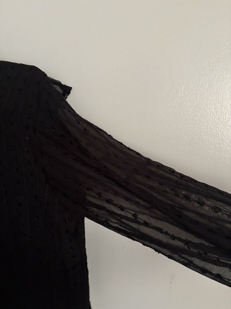 Black Ruffled Lace-Trim Blouse (Category: Blouses) located in Batangas. Submitted by soomi_8 (Listing ID 1460535488, Image 3). Description: Elegant all-black sheer blouse featuring delicate textured dot fabric throughout layered with ruffle detailing across the chest and shoulders It has a high neckline finished with fine scalloped lace, long flowy sleeves with ruffled cuffs, and a subtle keyhole closure at the back Lightweight and semi-sheer per