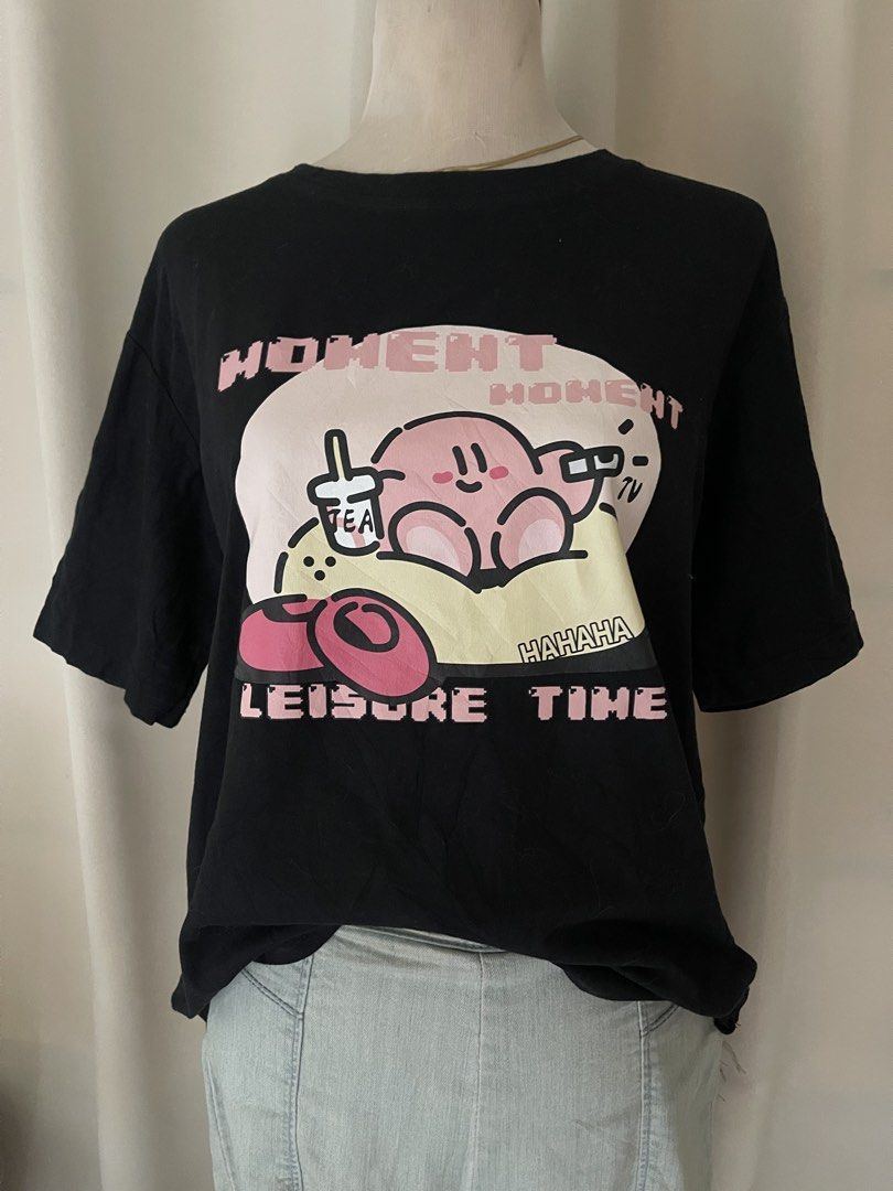 Black Tee Kirby "Leisure Time" (Category: Shirts) located in Cainta. Submitted by zlove111 (Listing ID 1460530848, Image 2). Description: - Black t-shirt with a fun, colorful Kirby graphic. - Features text: "Moment Moment", "Leisure Time", and "Hahaha". - Comfortable, oversized fit. - Ideal for casual everyday wear. up to 40 bust boxy no issue med-xl.