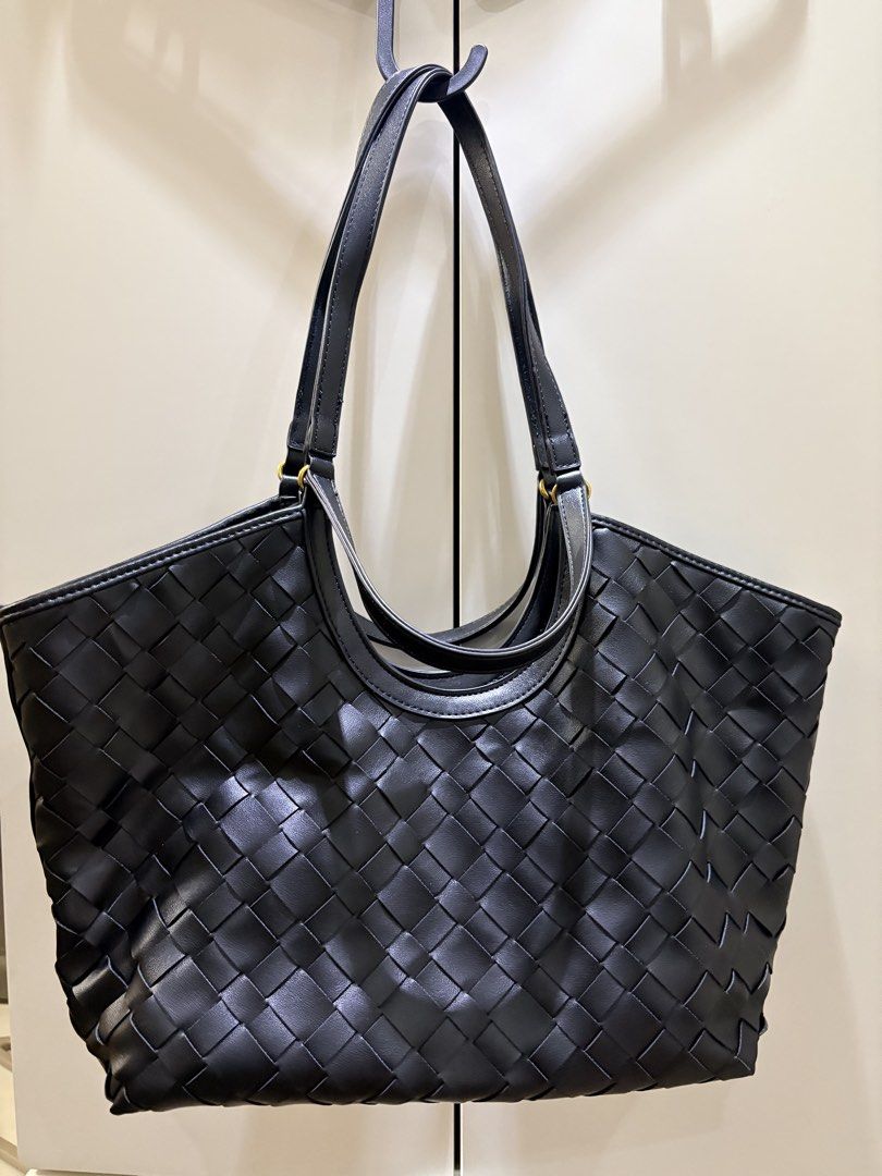 Black Woven Tote Bag (Category: Tote Bags) located in Mandaluyong City. Submitted by mariegeronimo (Listing ID 1460606533, Image 2). Description: - Stylish black woven tote bag - Includes leather pouch - Features an attractive all-over weave pattern - Smooth and comfortable handles - can be short or long - Ideal size for everyday essentials - Ample interior space - Versatile for work or casual outings.