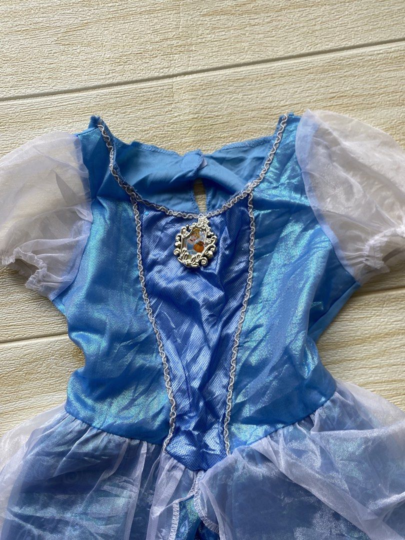 blue Cinderella costume dress (Category: Babies & Kids Fashion) located in Cebu City. Submitted by yjainani (Listing ID 1460526772, Image 3). Description: blue Cinderella costume dress featuring sheer puff sleeves and a character cameo pendant at the neckline.