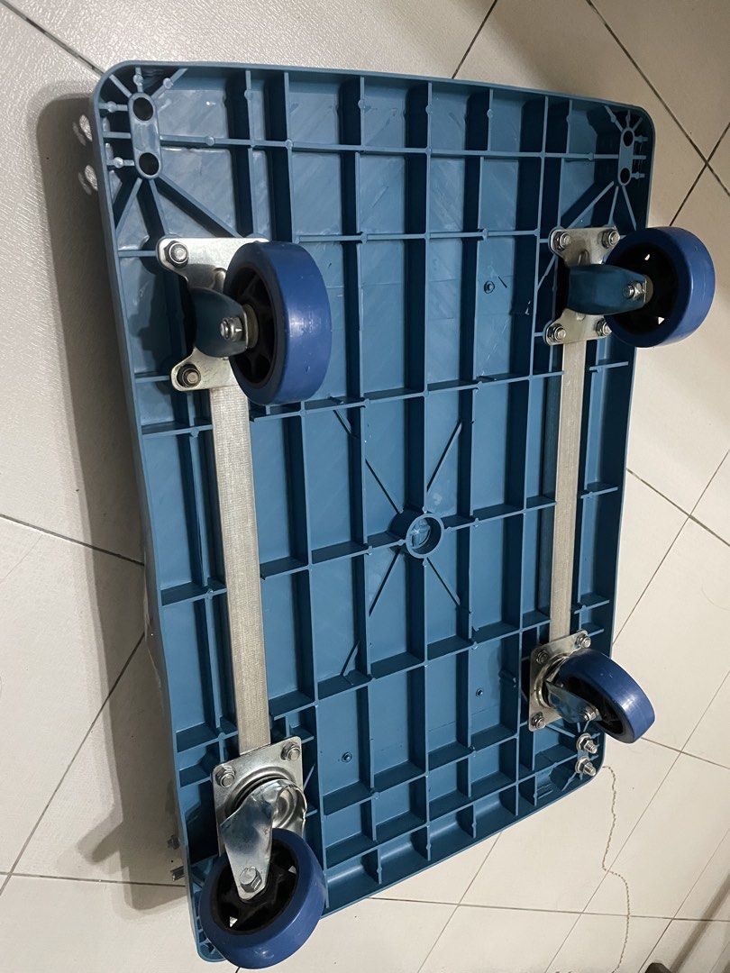 Blue Folding Trolley Cart with Wheels (Category: Industrial Equipment) located in Lipa City. Submitted by chacktg (Listing ID 1460637008, Image 3). Description: - Blue folding trolley cart - Sturdy metal handle and frame - Smooth rolling on four wheels - Folds flat for convenient storage - Ideal for moving boxes or heavy items - Handle is still wrapped in plastic.