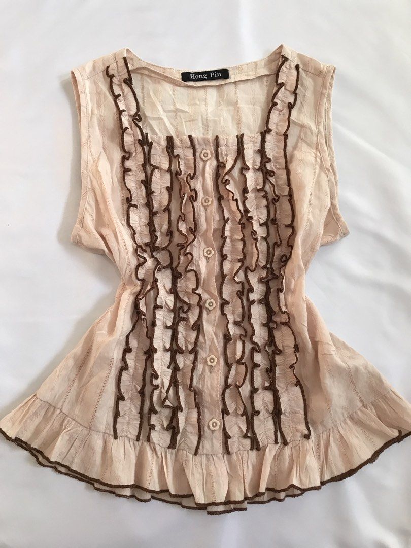 Blush Pink Sleeveless Blouse (Category: Blouses) located in Davao. Submitted by mira_e02 (Listing ID 1460631830, Image 1). Description: Ruffled detailing, brown embroidered trim and button-front closure. .