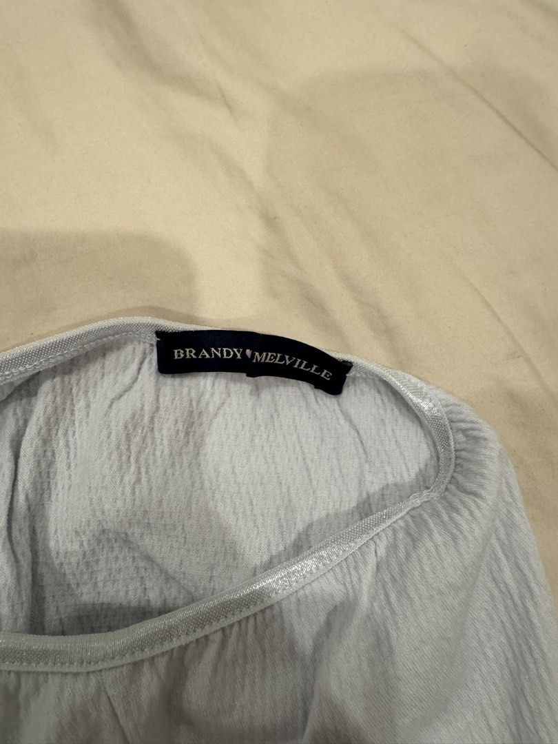 Brandy Melville Light Blue Crinkle Cami Top (Category: Sleeveless) located in Manila. Submitted by pinkyclothes1267 (Listing ID 1460637024, Image 3). Description: - Light blue Brandy Melville cami top - Crinkle texture all over - Lace trim along neckline and hem - Adjustable straps - Tie detail at the back - Lettuce hem finish - Super cute and comfy.