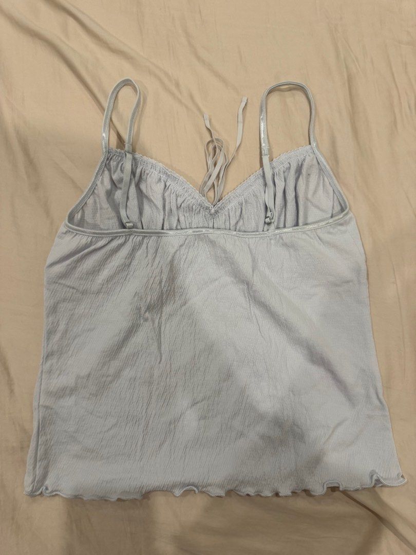 Brandy Melville Light Blue Crinkle Cami Top (Category: Sleeveless) located in Manila. Submitted by pinkyclothes1267 (Listing ID 1460637024, Image 2). Description: - Light blue Brandy Melville cami top - Crinkle texture all over - Lace trim along neckline and hem - Adjustable straps - Tie detail at the back - Lettuce hem finish - Super cute and comfy.