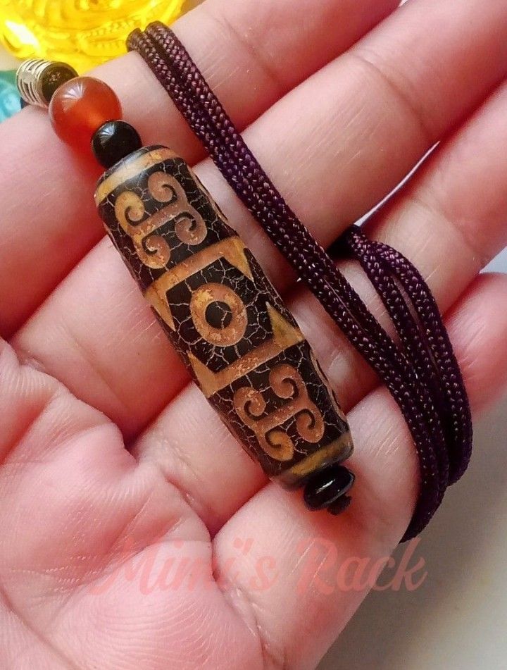 Brown Dzi Eye and Cloud Pattern Rope Necklace (Category: Necklaces) located in Taguig. Submitted by mimisrack (Listing ID 1460672636, Image 1). Description: 🤎A bold and symbolic necklace inspired by ancient Tibetan-style bead designs and earthy spiritual aesthetics -Detailed ancient-inspired patterns with crackled finish look -Accented with red and black beads for added contrast -Vintage-inspired piece with strong tribal and spiritual vibes -The
