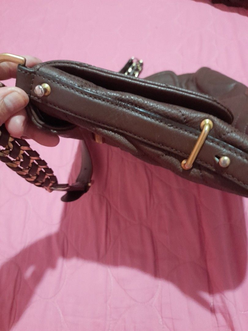 Brown Leather Embossed Shoulder Bag with Chain Strap (Category: Shoulder Bags) located in General Trias. Submitted by newberg0211 (Listing ID 1460657231, Image 3). Description: - Stylish brown leather shoulder bag - All-over embossed logo pattern for a touch of luxury - Convenient front zip pocket for quick access - Unique strap combining leather and gold chain - Secure magnetic closure inside - Ideal size for everyday use and carrying your essen