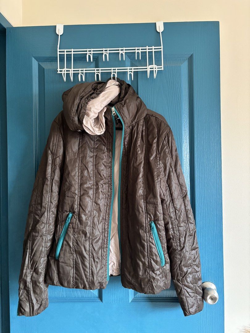 Brown Puffer Jacket with Teal Accents (Category: Coats, Jackets and Outerwear) located in Makati City. Submitted by yunivances (Listing ID 1460522784, Image 1). Description: - Brown puffer jacket - Light pink lining - Teal zippers on pockets and front closure - Attached hood - Ideal for cooler weather - Lightweight and easy to pack.