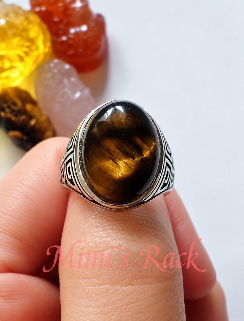 Brown Tiger's Eye Oval Vintage Design Ring (Category: Rings) located in Taguig. Submitted by mimisrack (Listing ID 1460679848, Image 3). Description: 🤎A bold tiger's eye ring with mesmerizing golden flashes that shift beautifully under the light powerful, classy, and timeless -Features a polished natural tiger's eye cabochon stone -Beautiful golden-brown chatoyancy -detailed engraved band design -Tiger's eye is associated with protection, confid