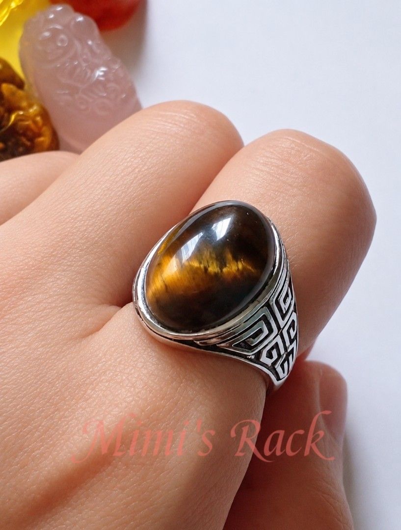 Brown Tiger's Eye Oval Vintage Design Ring (Category: Rings) located in Taguig. Submitted by mimisrack (Listing ID 1460679848, Image 1). Description: 🤎A bold tiger's eye ring with mesmerizing golden flashes that shift beautifully under the light powerful, classy, and timeless -Features a polished natural tiger's eye cabochon stone -Beautiful golden-brown chatoyancy -detailed engraved band design -Tiger's eye is associated with protection, confid