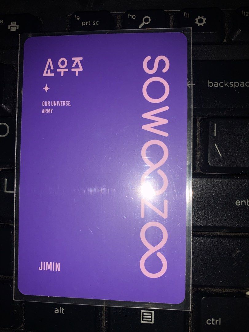 BTS Jimin Sowoozoo Photocard (Category: K-Wave Merchandise) located in Caloocan City. Submitted by Kristina7 (Listing ID 1460704540, Image 2). Description: - Jimin photocard from BTS Sowoozoo - Features Jimin in a yellow top and white shirt - Back is purple with Sowoozoo logo and text - Essential addition to any ARMY collection - Own a piece of BTS history! - Price is negotiable.