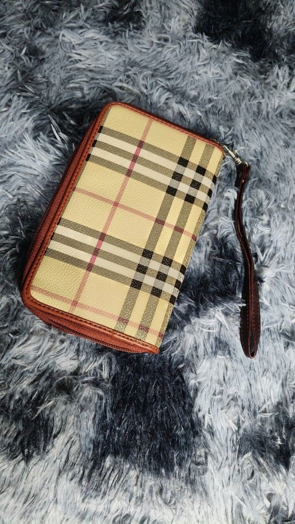 Burberry Checkered Zip Around Wallet with Wrist Strap (Category: Luxury Bags & Wallets) located in Manila. Submitted by serenitycarlylle (Listing ID 1460705275, Image 1). Description: Classic Burberry checkered wallet. Tan and red plaid pattern. Zip around closure. Interior has multiple compartments and card slots. Comes with a detachable wrist strap. Good for organizing essentials..