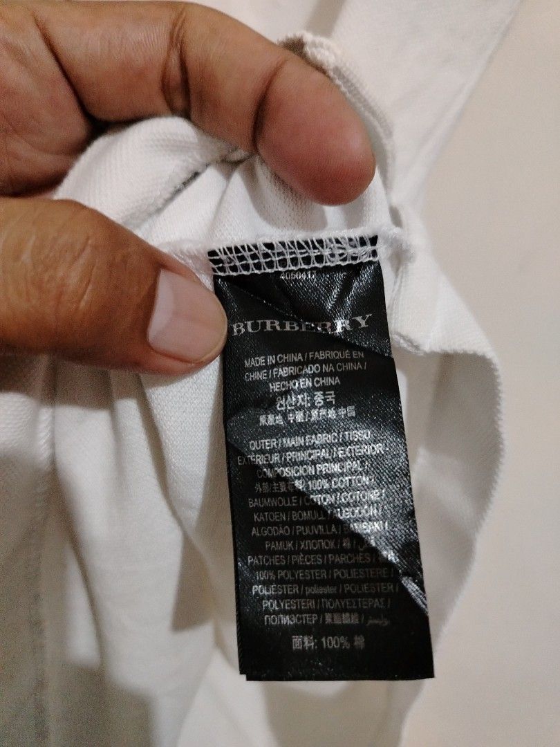 Burberry White Polo Shirt with Patch - Size M (Category: Tshirts & Polo Shirts ) located in Cavite. Submitted by koyawell.ph (Listing ID 1460666156, Image 3). Description: - Authentic Burberry Polo Shirt - Size: Medium - 19 x 28 dimensions - Material: 100% Cotton - Features a cool embroidered patch on the chest - Ideal for casual outings - Please check photos for detailed condition.