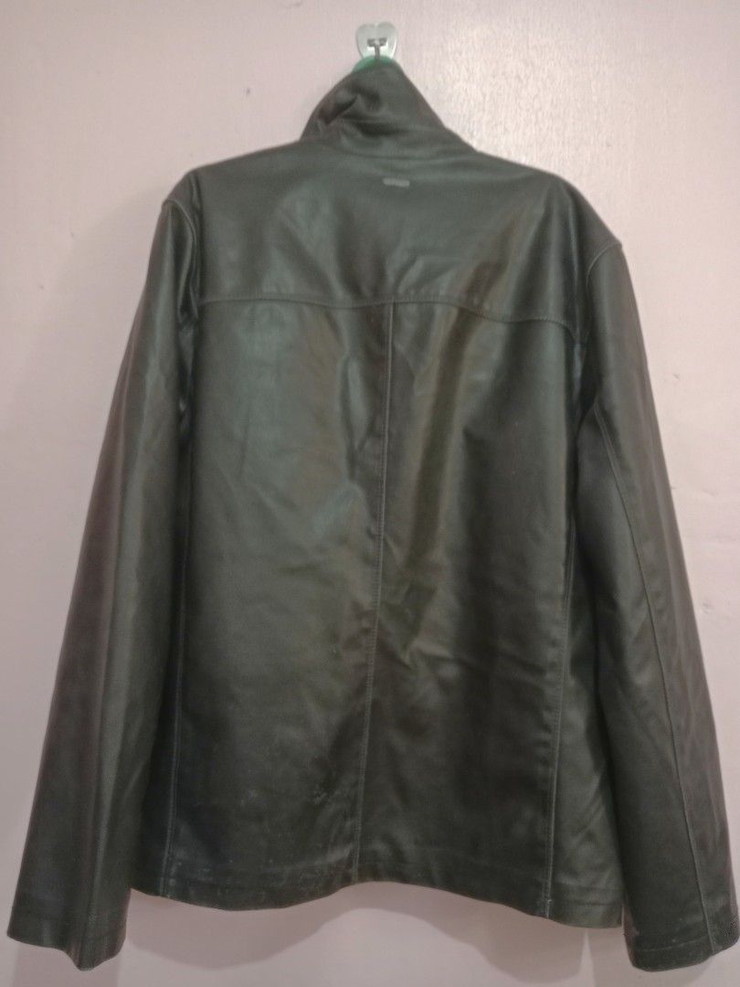 Calvin Klein leather jacket (Category: Coats, Jackets and Outerwear) located in Naga. Submitted by thrift.vincent (Listing ID 1460559229, Image 2). Description: Calvin Klein black faux leather full zip jacket in men's medium. Funnel neck collar, two side hand pockets, horizontal chest seam, and vertical center seam on the back. Calvin Klein branded metal zipper pull and small metal logo plate on the upper back. Quilted interior lining. Shell face