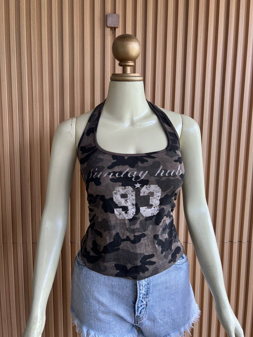Camo Halter Tank Top with '93' Graphic (Category: Sleeveless) located in Lipa City. Submitted by thyra06 (Listing ID 1460644339, Image 2). Description: - Trendy camo print halter tank top - Features 'Sunday Hub' and '93' graphic on the front - Made with stretchy material for a comfortable fit - Perfect for casual outfits or as a layering piece - Pairs well with shorts or jeans.