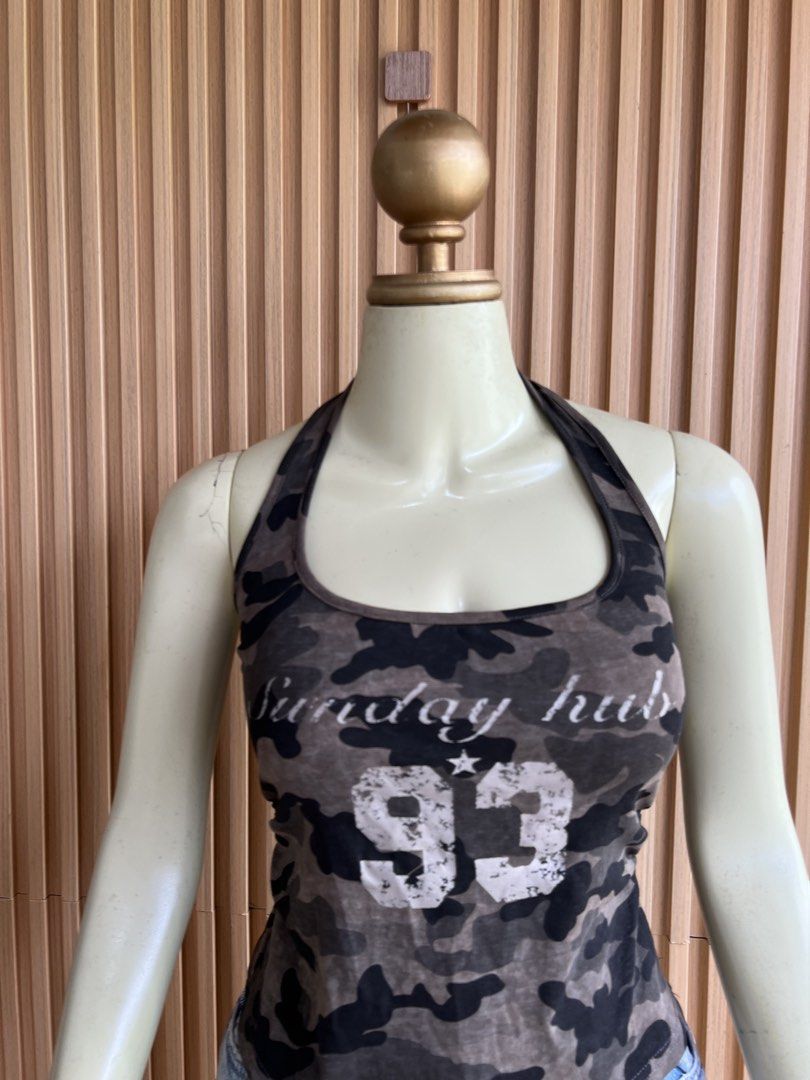 Camo Halter Tank Top with '93' Graphic (Category: Sleeveless) located in Lipa City. Submitted by thyra06 (Listing ID 1460644339, Image 3). Description: - Trendy camo print halter tank top - Features 'Sunday Hub' and '93' graphic on the front - Made with stretchy material for a comfortable fit - Perfect for casual outfits or as a layering piece - Pairs well with shorts or jeans.