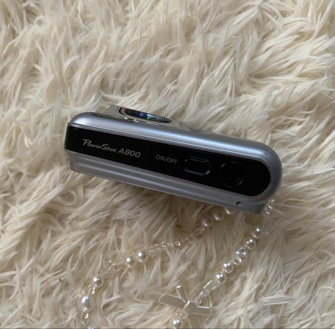 Canon PowerShot A800 10MP Digital Camera – Silver (Category: Cameras) located in Lubao. Submitted by julian_sampang (Listing ID 1460509624, Image 2). Description: READ BEFORE DM 💰 PRICE: ₱4,500 (fixed) 📍 MEET-UP: Pampanga Area INCLUSIONS: * Canon PowerShot A800 Digital Camera * 6 Batteries * Camera Bag * Charger CONDITION: * Overall good condition for its age * No visible signs of vignette, dust, or other issues in the lens. * Powers on properl