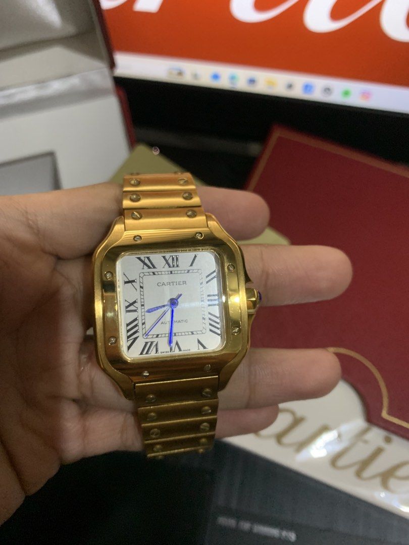 Cartier Santos Galbee Automatic Gold Watch (Category: Luxury Watches) located in Dasmarinas. Submitted by prerogathrift (Listing ID 1460713986, Image 3). Description: -mid tier watch - Cartier Santos Galbee Automatic Watch - Luxurious Gold Casing - Classic Roman Numeral Dial - Signature Blue Hands - Comes with Box - Includes International Guarantee Card .