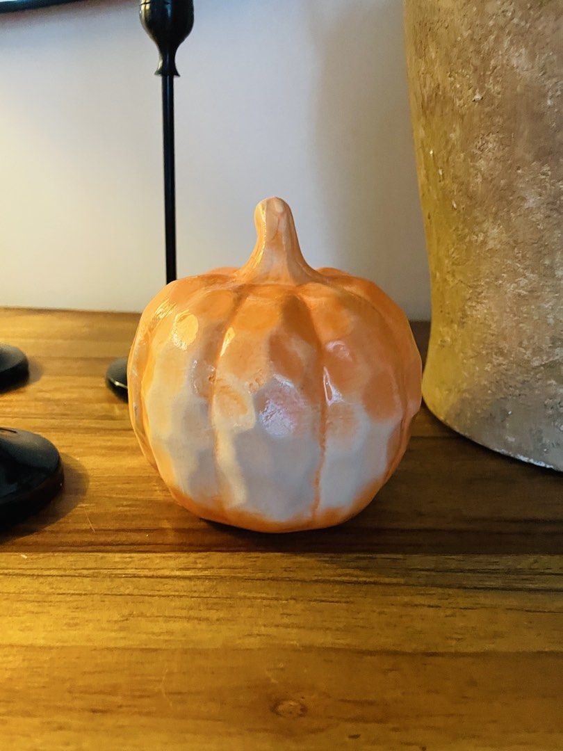 Ceramic Pumpkin Decor (Category: Other Home Decor) located in Quezon City. Submitted by catlover18 (Listing ID 1460554995, Image 2). Description: - 4inch height - Glossy orange ceramic finish - Classic pumpkin shape with textured ridges - Beautiful as a standalone accent piece - Perfect for fall, Halloween, Thanksgiving, or everyday autumn décor - Great for coffee tables, shelves, consoles, dining tables, or mantels - Condition: pre-owned, faded 