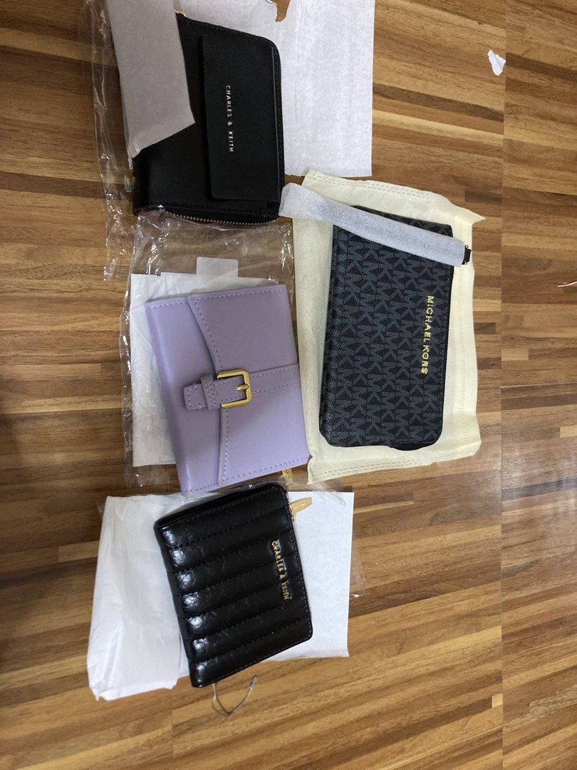 Charles & Keith and Michael Kors Wallets/Cardholder (Category: Wallets & Card holders) located in Manila. Submitted by abengjoy30 (Listing ID 1460666615, Image 1). Description: - Bundle includes 3 wallets and 1 cardholder. - Charles & Keith black zip-around wallet. - Charles & Keith black bi-fold wallet. - Light purple bi-fold wallet with gold buckle. - Michael Kors black & grey cardholder..