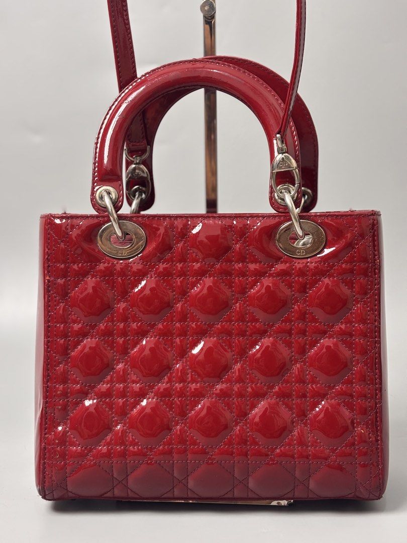 Christian Dior Lady Dior Bag (Category: Luxury Bags & Wallets) located in Quezon City. Submitted by lucky.purelux.ph (Listing ID 1460663444, Image 2). Description: red patent leather Christian Dior Lady Dior Bag featuring signature Cannage quilting and silver-tone D.I.O.R. hanging charms. ⚠️ ITEM ISSUE / CONDITION May minor signs of usage lang due to normal wear. Please check all photos carefully for the actual condition. ✨ Overall, good conditio