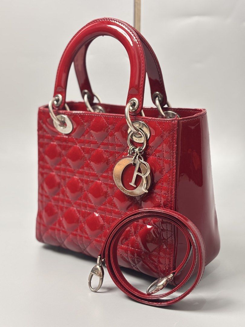 Christian Dior Lady Dior Bag (Category: Luxury Bags & Wallets) located in Quezon City. Submitted by lucky.purelux.ph (Listing ID 1460663444, Image 1). Description: red patent leather Christian Dior Lady Dior Bag featuring signature Cannage quilting and silver-tone D.I.O.R. hanging charms. ⚠️ ITEM ISSUE / CONDITION May minor signs of usage lang due to normal wear. Please check all photos carefully for the actual condition. ✨ Overall, good conditio