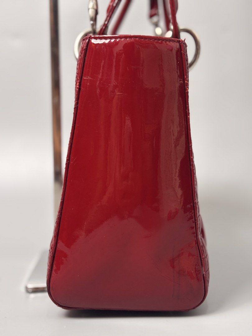 Christian Dior Lady Dior Bag (Category: Luxury Bags & Wallets) located in Quezon City. Submitted by lucky.purelux.ph (Listing ID 1460663444, Image 3). Description: red patent leather Christian Dior Lady Dior Bag featuring signature Cannage quilting and silver-tone D.I.O.R. hanging charms. ⚠️ ITEM ISSUE / CONDITION May minor signs of usage lang due to normal wear. Please check all photos carefully for the actual condition. ✨ Overall, good conditio