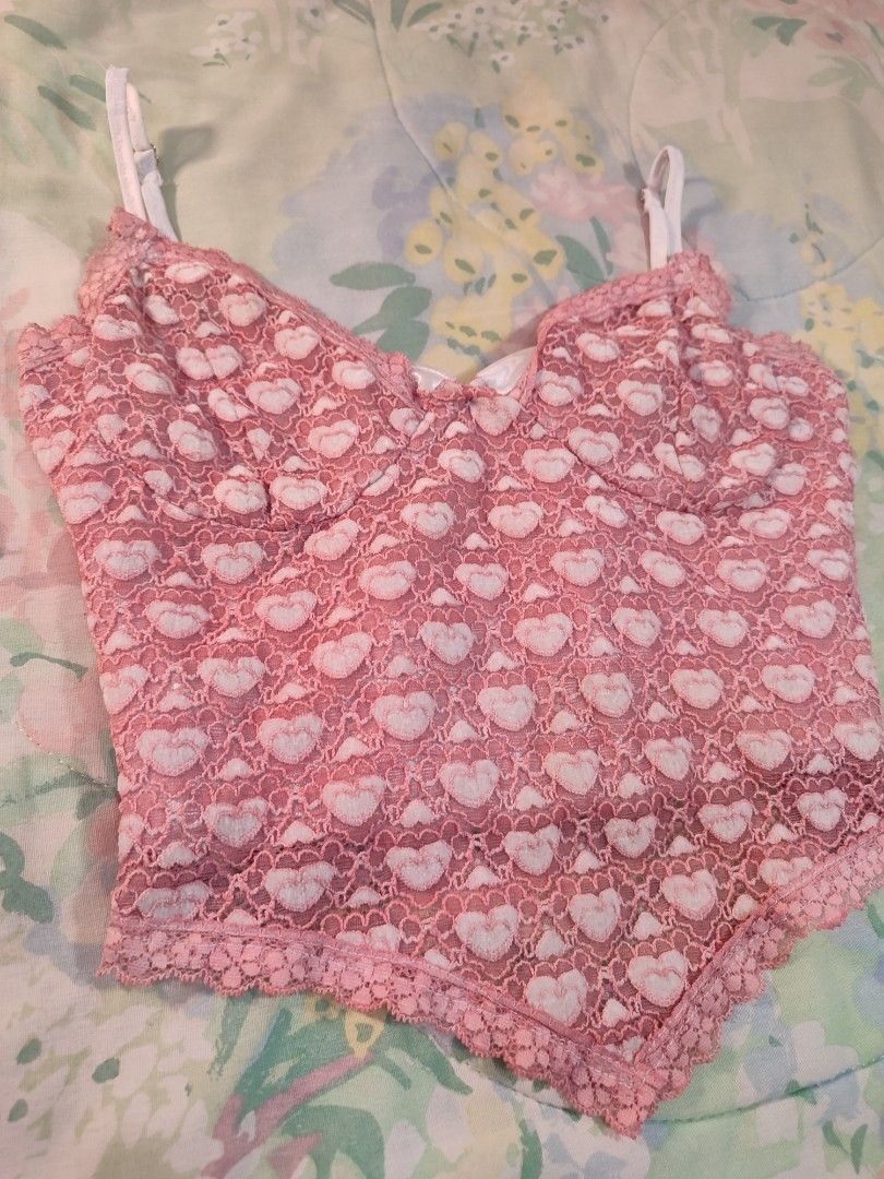 CIDER Pink Heart Lace Top (Category: Sleeveless) located in Jaen. Submitted by roxantiago (Listing ID 1460535048, Image 2). Description: - Cute pink lace crop top - Adorable heart pattern - Adjustable straps for a perfect fit - Lined bust for comfort and support - Delicate lace trim at the hem - Sweet yet edgy vibe - Versatile for nights out or elevating everyday outfits temporarily adjusted to Small. original size can fit M to L has runs sa stra