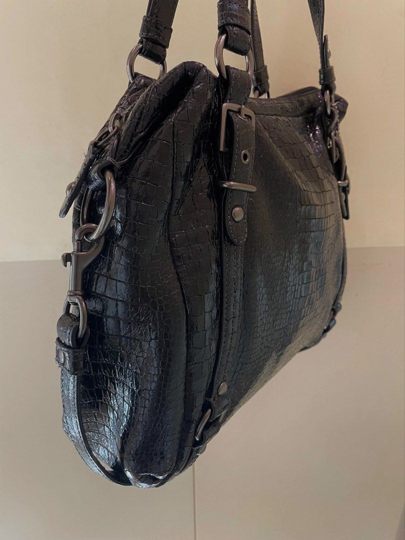 Coach Alexandra Handbag (Category: Luxury Bags & Wallets) located in Manila. Submitted by thevintagebow (Listing ID 1460710742, Image 3). Description: Bold texture meets timeless elegance. ✨ Elevate your rotation with this chic Coach Alexandra Handbag in luxurious black crocodile-embossed leather. Featuring an edgy gunmetal hardware, distinctive buckled strap accents, dual top handles, and a gorgeous teal interior lining, it’s the perfect mix of 