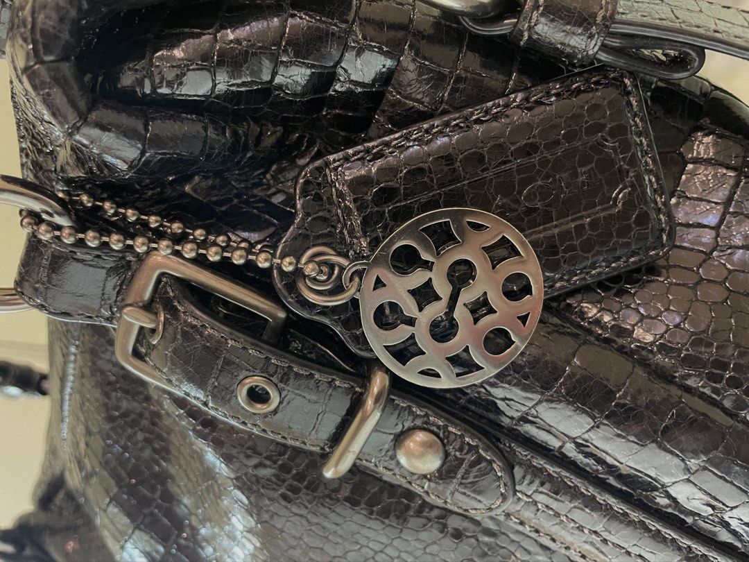 Coach Alexandra Handbag (Category: Luxury Bags & Wallets) located in Manila. Submitted by thevintagebow (Listing ID 1460710742, Image 2). Description: Bold texture meets timeless elegance. ✨ Elevate your rotation with this chic Coach Alexandra Handbag in luxurious black crocodile-embossed leather. Featuring an edgy gunmetal hardware, distinctive buckled strap accents, dual top handles, and a gorgeous teal interior lining, it’s the perfect mix of 
