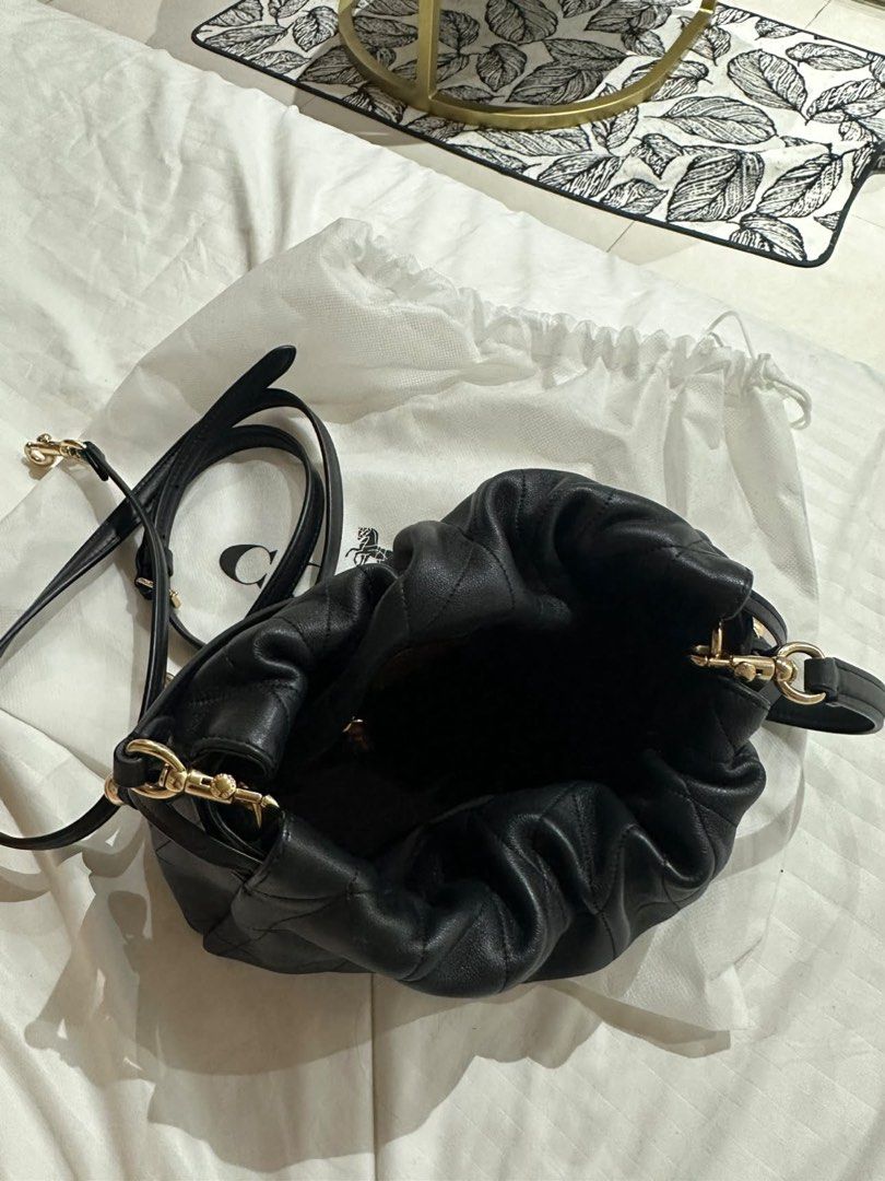 Coach Black Quilted Leather Drawstring Shoulder Bag (Category: Luxury Bags & Wallets) located in Manila. Submitted by denchoscloset (Listing ID 1460662875, Image 3). Description: perfectly mint/unused condition bag without flaws or signs of usage ❤️ bought it in japan used once only! Condition: 10/10 (pristine condition) Material: Ultra-soft quilted Nappa leather Details: Gold-tone horse & carriage hardware, beautiful scrunchable drawstring aesth