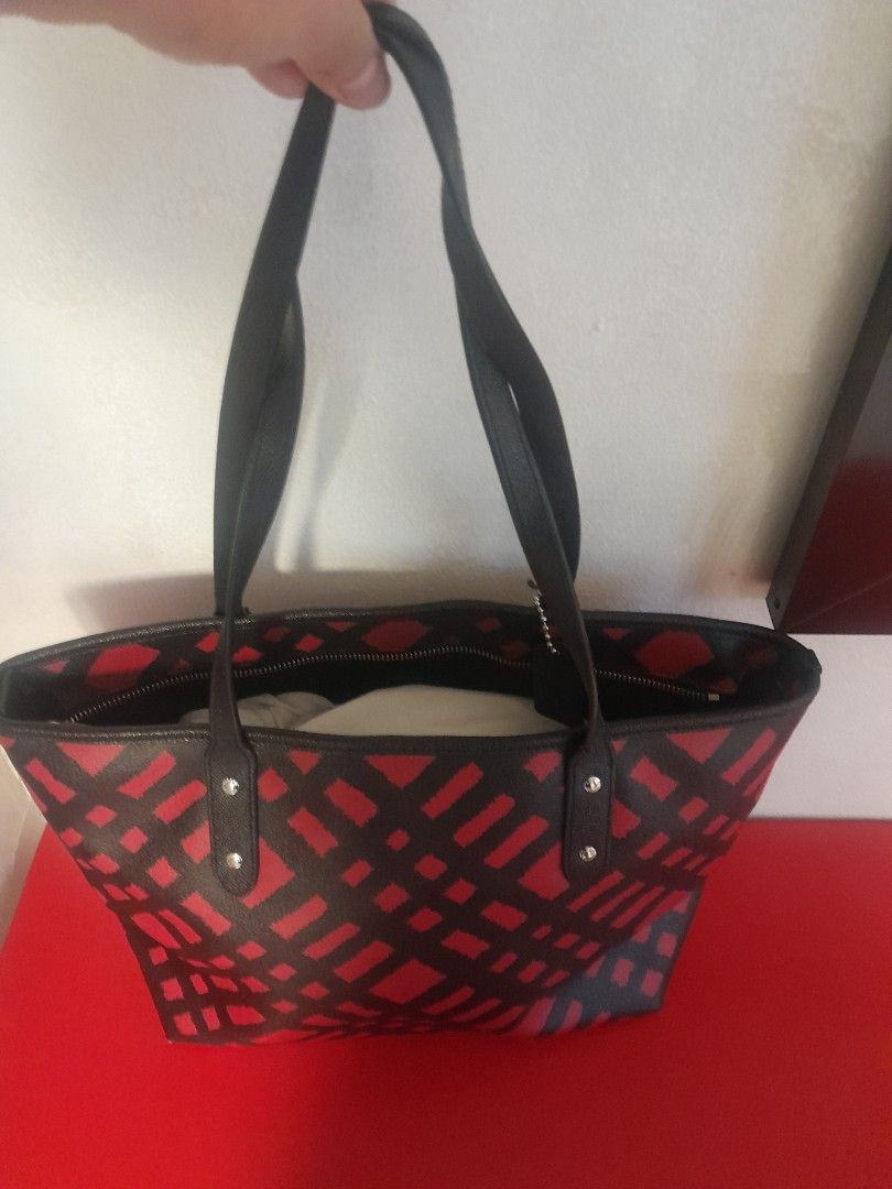 Coach Black Red Geometric Print Tote Bag (Category: Tote Bags) located in Manila. Submitted by glengpascu18784 (Listing ID 1460583830, Image 2). Description: - Stylish Coach tote bag - Eye-catching black and red geometric pattern - Genuine leather handles and trim - Secure zipper closure for the main compartment - Interior zippered pocket and slip pockets - Ample space for daily essentials - Ideal for work or casual outings.