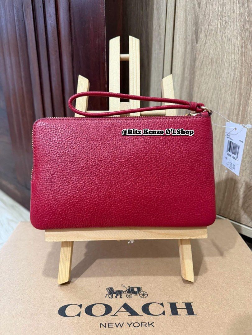 Coach Double Zip Wallet Wristlet Red Pebbled Leather (Category: Wallets & Card holders) located in Antipolo. Submitted by ritzkenzo_olshop06 (Listing ID 1460538042, Image 2). Description: - Coach double zip wristlet - Color: Red - Material: Pebbled leather - Hardware: Gold - Two main zip compartments - Interior card slots - Detachable wrist strap - Ideal for carrying essentials.