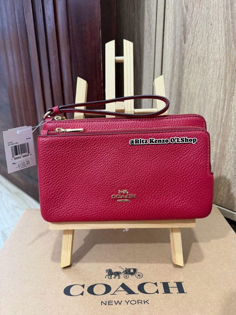 Coach Double Zip Wallet Wristlet Red Pebbled Leather (Category: Wallets & Card holders) located in Antipolo. Submitted by ritzkenzo_olshop06 (Listing ID 1460538042, Image 1). Description: - Coach double zip wristlet - Color: Red - Material: Pebbled leather - Hardware: Gold - Two main zip compartments - Interior card slots - Detachable wrist strap - Ideal for carrying essentials.