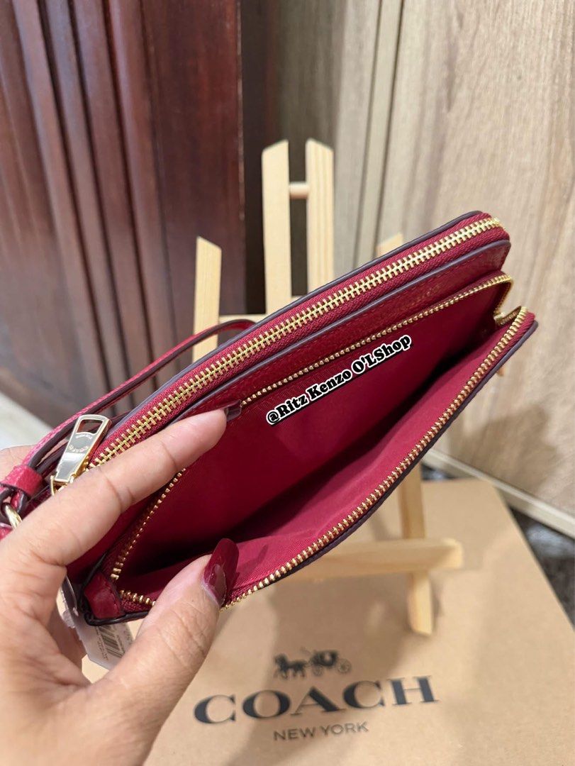 Coach Double Zip Wallet Wristlet Red Pebbled Leather (Category: Wallets & Card holders) located in Antipolo. Submitted by ritzkenzo_olshop06 (Listing ID 1460538042, Image 3). Description: - Coach double zip wristlet - Color: Red - Material: Pebbled leather - Hardware: Gold - Two main zip compartments - Interior card slots - Detachable wrist strap - Ideal for carrying essentials.
