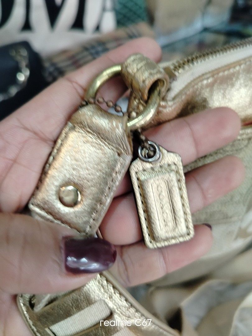 Coach Gold Patchwork Crossbody Bag (Category: Luxury Bags & Wallets) located in Bacolod City. Submitted by Mike23MattPreloved (Listing ID 1460544261, Image 3). Description: - Authentic Coach Gold Patchwork Crossbody Bag - Features a mix of textures and signature Coach pattern - Adjustable strap for comfortable, customizable fit - Secure zipper closure - Versatile for everyday use or evening outings - Comes with original Coach hang tags.