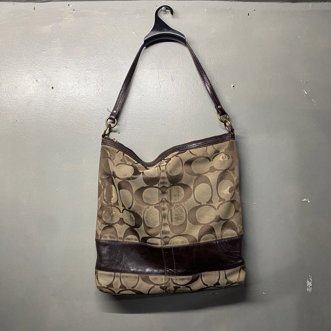 Coach Monogram Canvas Leather Trim Hobo Shoulder Bag (Category: Luxury Bags & Wallets) located in Cagayan de Oro. Submitted by sumamestreethub (Listing ID 1460610984, Image 2). Description: - Classic Coach hobo bag - Signature monogram canvas - Dark brown leather trim and straps - Brown fabric interior lining - Secure zipper closure - Spacious for essentials - Ideal everyday bag.