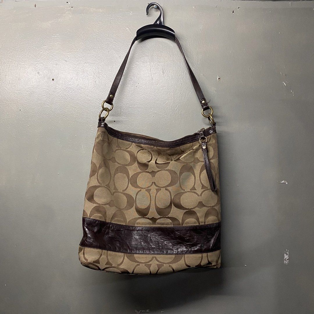 Coach Monogram Canvas Leather Trim Hobo Shoulder Bag (Category: Luxury Bags & Wallets) located in Cagayan de Oro. Submitted by sumamestreethub (Listing ID 1460610984, Image 1). Description: - Classic Coach hobo bag - Signature monogram canvas - Dark brown leather trim and straps - Brown fabric interior lining - Secure zipper closure - Spacious for essentials - Ideal everyday bag.