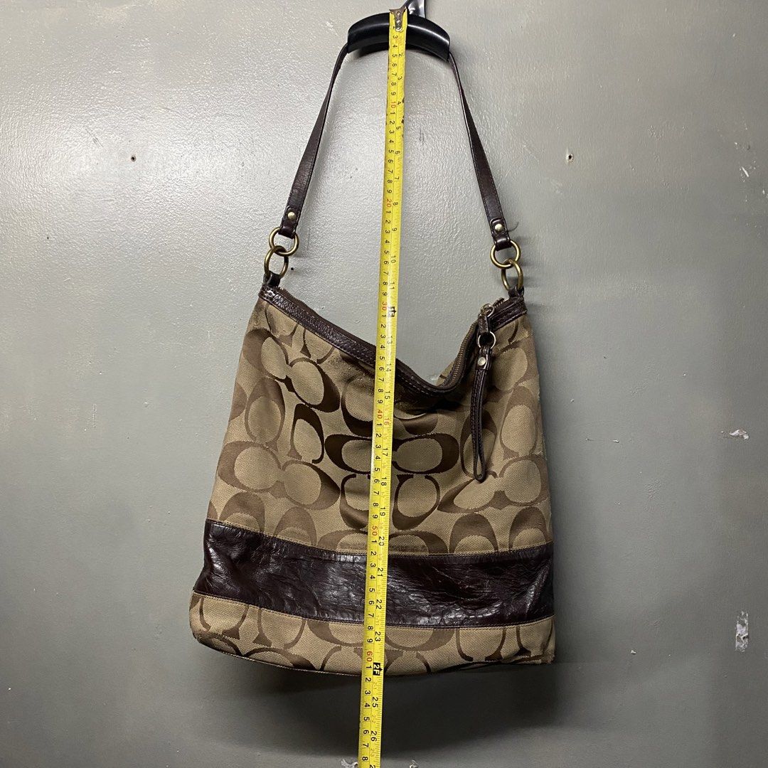 Coach Monogram Canvas Leather Trim Hobo Shoulder Bag (Category: Luxury Bags & Wallets) located in Cagayan de Oro. Submitted by sumamestreethub (Listing ID 1460610984, Image 3). Description: - Classic Coach hobo bag - Signature monogram canvas - Dark brown leather trim and straps - Brown fabric interior lining - Secure zipper closure - Spacious for essentials - Ideal everyday bag.