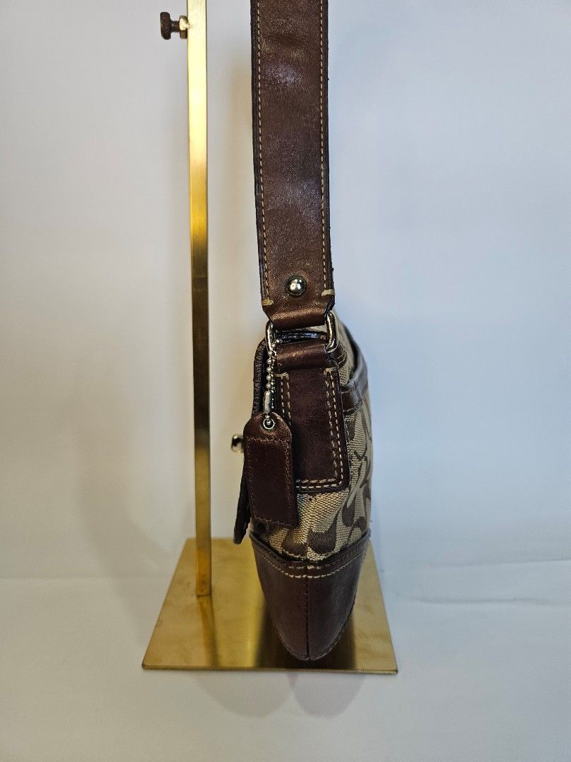 Coach Monogram Canvas Leather Trim Shoulder Bag (Category: Luxury Bags & Wallets) located in Balanga. Submitted by prelovedat1stsight (Listing ID 1460652793, Image 3). Description: - Classic Coach monogram shoulder bag - Color: Brown canvas with leather trim - Closure: Turn-lock - Strap: Adjustable with buckle - Condition: Rank A, great for everyday use..