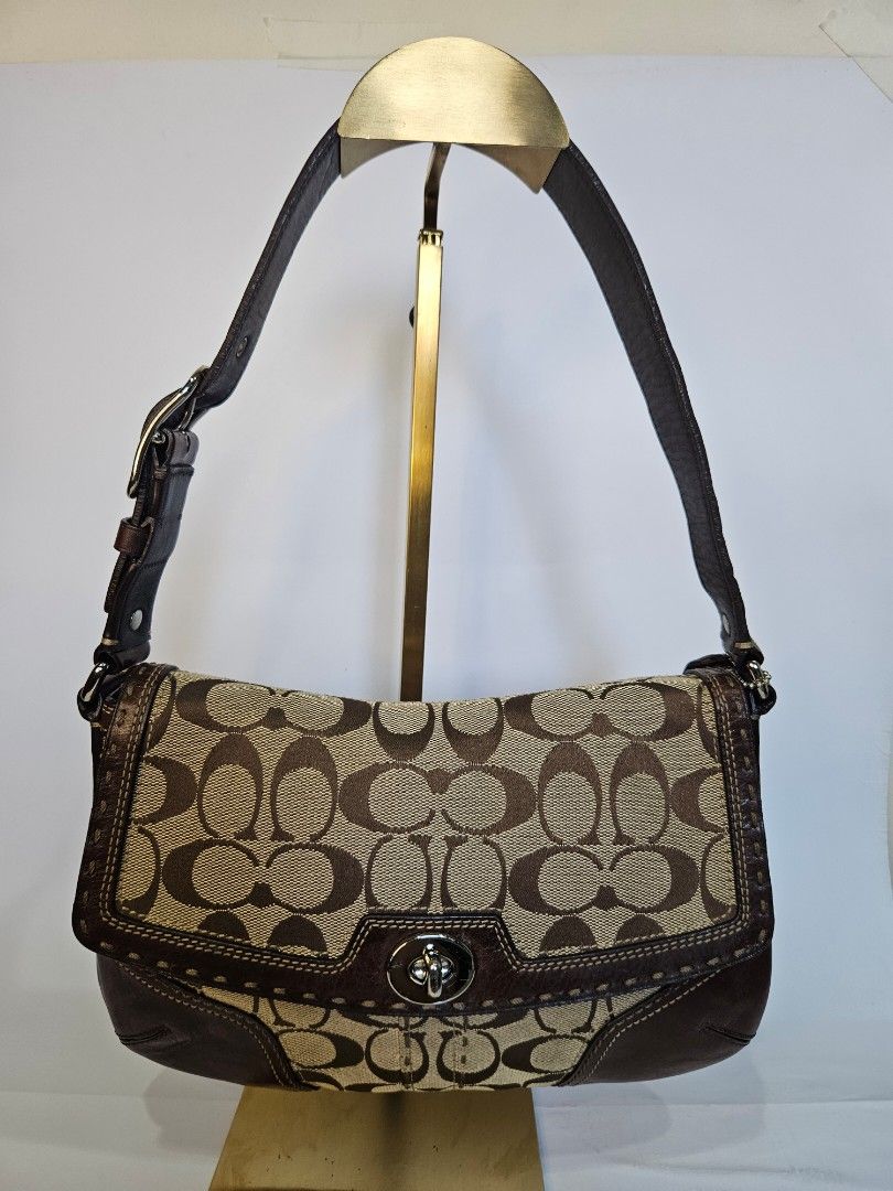 Coach Monogram Canvas Leather Trim Shoulder Bag (Category: Luxury Bags & Wallets) located in Balanga. Submitted by prelovedat1stsight (Listing ID 1460652793, Image 1). Description: - Classic Coach monogram shoulder bag - Color: Brown canvas with leather trim - Closure: Turn-lock - Strap: Adjustable with buckle - Condition: Rank A, great for everyday use..