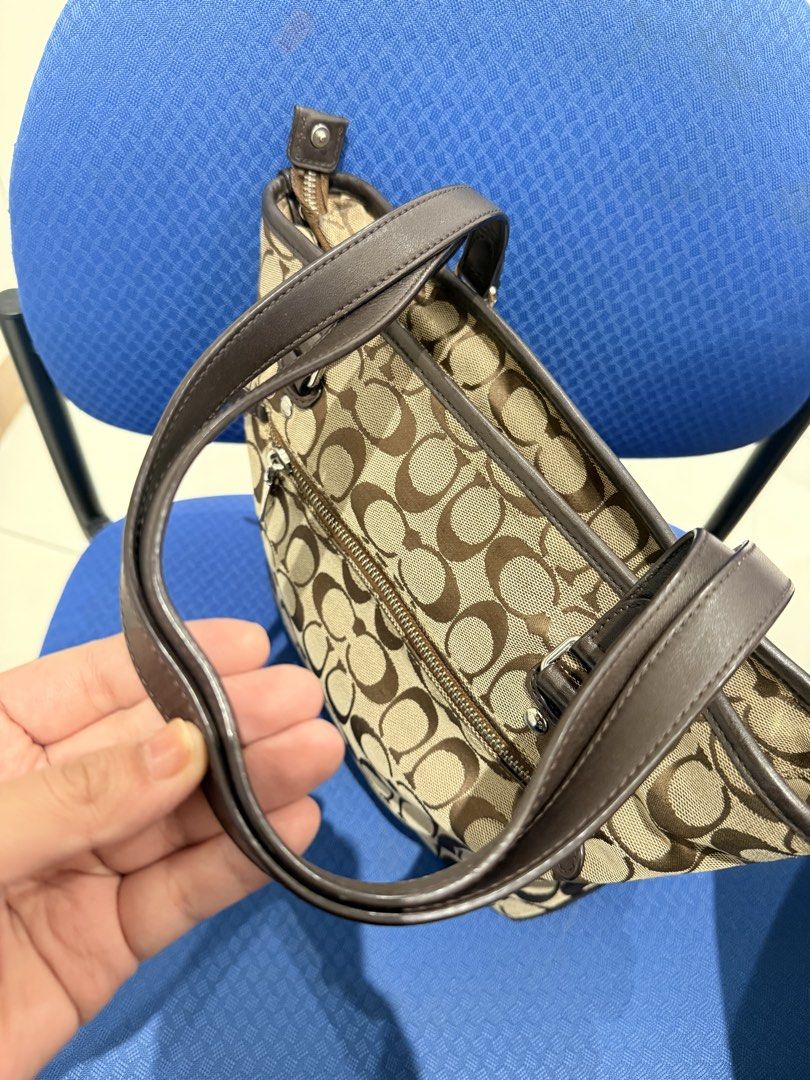 Coach Monogram Canvas Tote Bag with Leather Trim (Category: Luxury Bags & Wallets) located in Manila. Submitted by angelcurated (Listing ID 1460567837, Image 3). Description: - Classic Coach monogram tote bag - Color: Brown and tan signature 'C' pattern - Material: Leather handles and trim - Closure: Top zipper - Exterior: Front zipper pocket - Extras: Comes with cute bag charms - Interior: Plenty of space for essentials - Style: Great everyday b