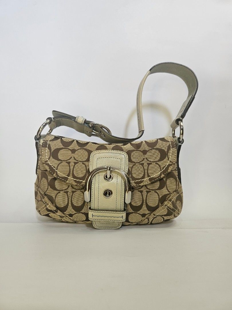 Coach Monogram Shoulder Bag (Category: Luxury Bags & Wallets) located in Balanga. Submitted by prelovedat1stsight (Listing ID 1460616559, Image 1). Description: - Authentic Coach monogram shoulder bag - Classic brown and tan signature pattern - Cream leather trim and adjustable strap - Silver buckle detail on the front flap - Comes with original Coach dust bag - A timeless and iconic Coach accessory - Rank A condition.