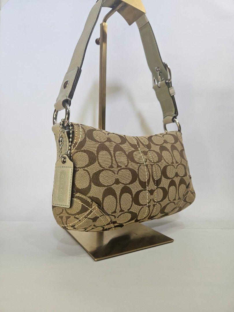 Coach Monogram Shoulder Bag (Category: Luxury Bags & Wallets) located in Balanga. Submitted by prelovedat1stsight (Listing ID 1460616559, Image 3). Description: - Authentic Coach monogram shoulder bag - Classic brown and tan signature pattern - Cream leather trim and adjustable strap - Silver buckle detail on the front flap - Comes with original Coach dust bag - A timeless and iconic Coach accessory - Rank A condition.