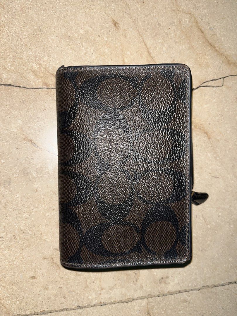 Coach Signature Canvas Trifold Wallet (Category: Luxury Bags & Wallets) located in Makati City. Submitted by aliyahprieto949 (Listing ID 1460630530, Image 2). Description: - Authentic Coach trifold wallet - Classic brown and black signature C print - Secure snap closure - Convenient zip coin pocket - Multiple interior card slots - Clear ID window - Minor signs of wear on inside edges and ID window - Plenty of life left, great value!.