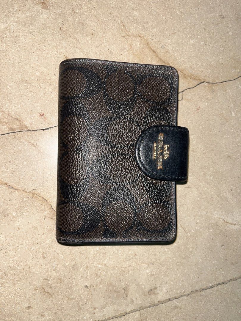 Coach Signature Canvas Trifold Wallet (Category: Luxury Bags & Wallets) located in Makati City. Submitted by aliyahprieto949 (Listing ID 1460630530, Image 1). Description: - Authentic Coach trifold wallet - Classic brown and black signature C print - Secure snap closure - Convenient zip coin pocket - Multiple interior card slots - Clear ID window - Minor signs of wear on inside edges and ID window - Plenty of life left, great value!.