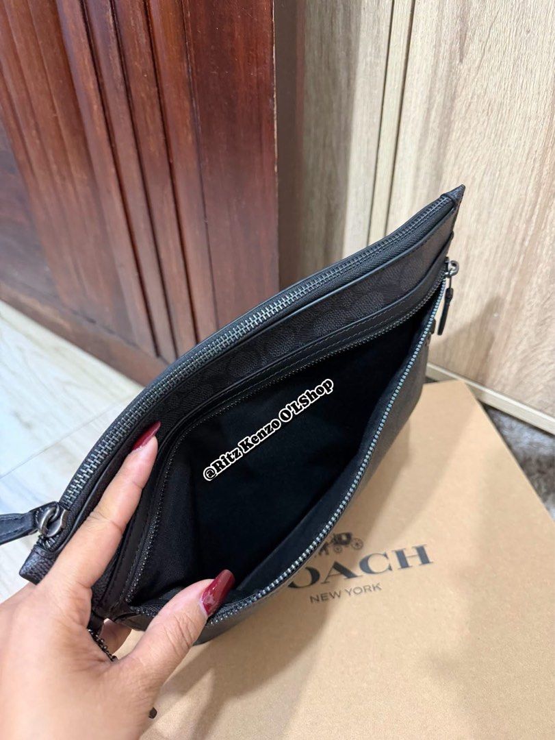 Coach Signature Monogram Clutch Bag (Category: Clutches) located in Antipolo. Submitted by ritzkenzo_olshop06 (Listing ID 1460537257, Image 3). Description: - Authentic Coach clutch bag - Signature monogram print in black and grey - Main zippered compartment - Front zippered pocket - Interior card slots and small pouch - Detachable wrist strap - Includes original dust bag and authenticity card - Ideal for everyday use or travel.