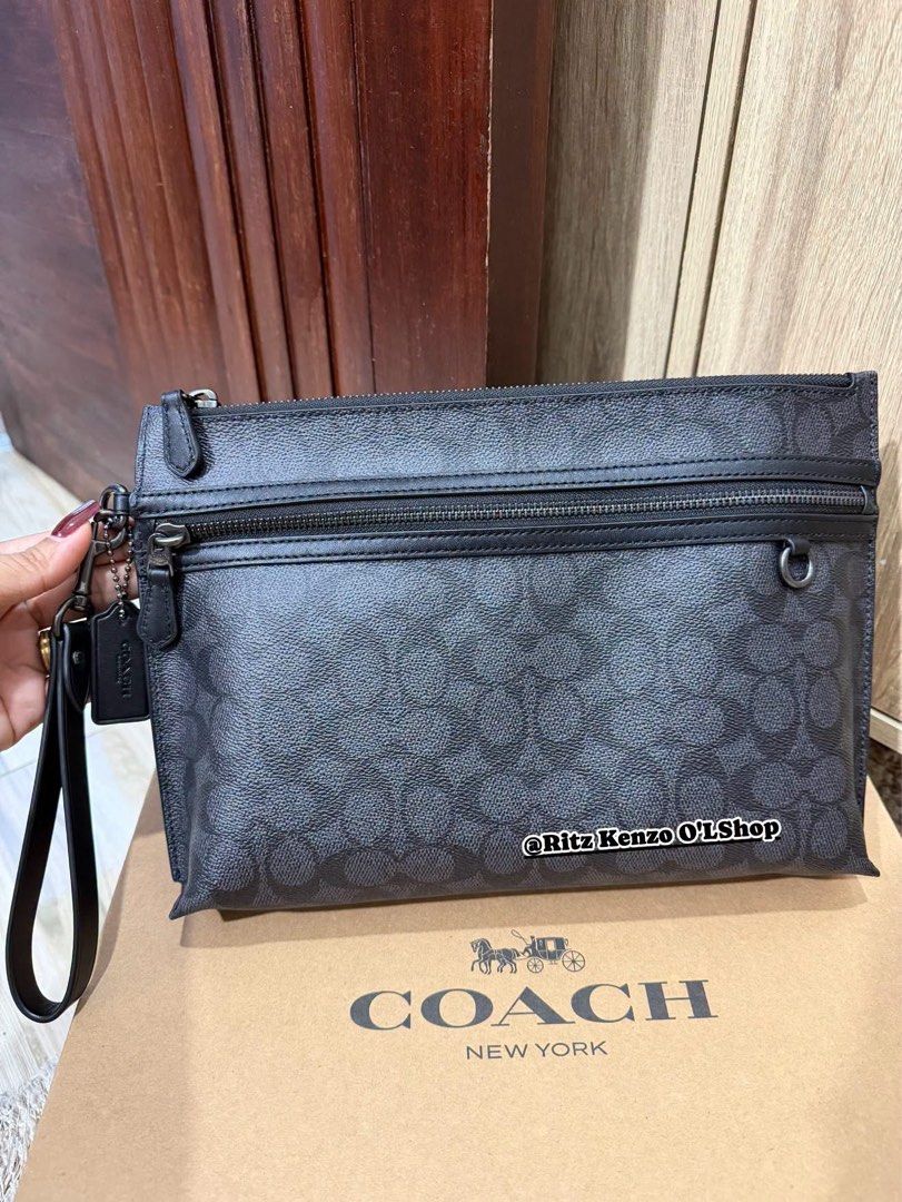 Coach Signature Monogram Clutch Bag (Category: Clutches) located in Antipolo. Submitted by ritzkenzo_olshop06 (Listing ID 1460537257, Image 1). Description: - Authentic Coach clutch bag - Signature monogram print in black and grey - Main zippered compartment - Front zippered pocket - Interior card slots and small pouch - Detachable wrist strap - Includes original dust bag and authenticity card - Ideal for everyday use or travel.
